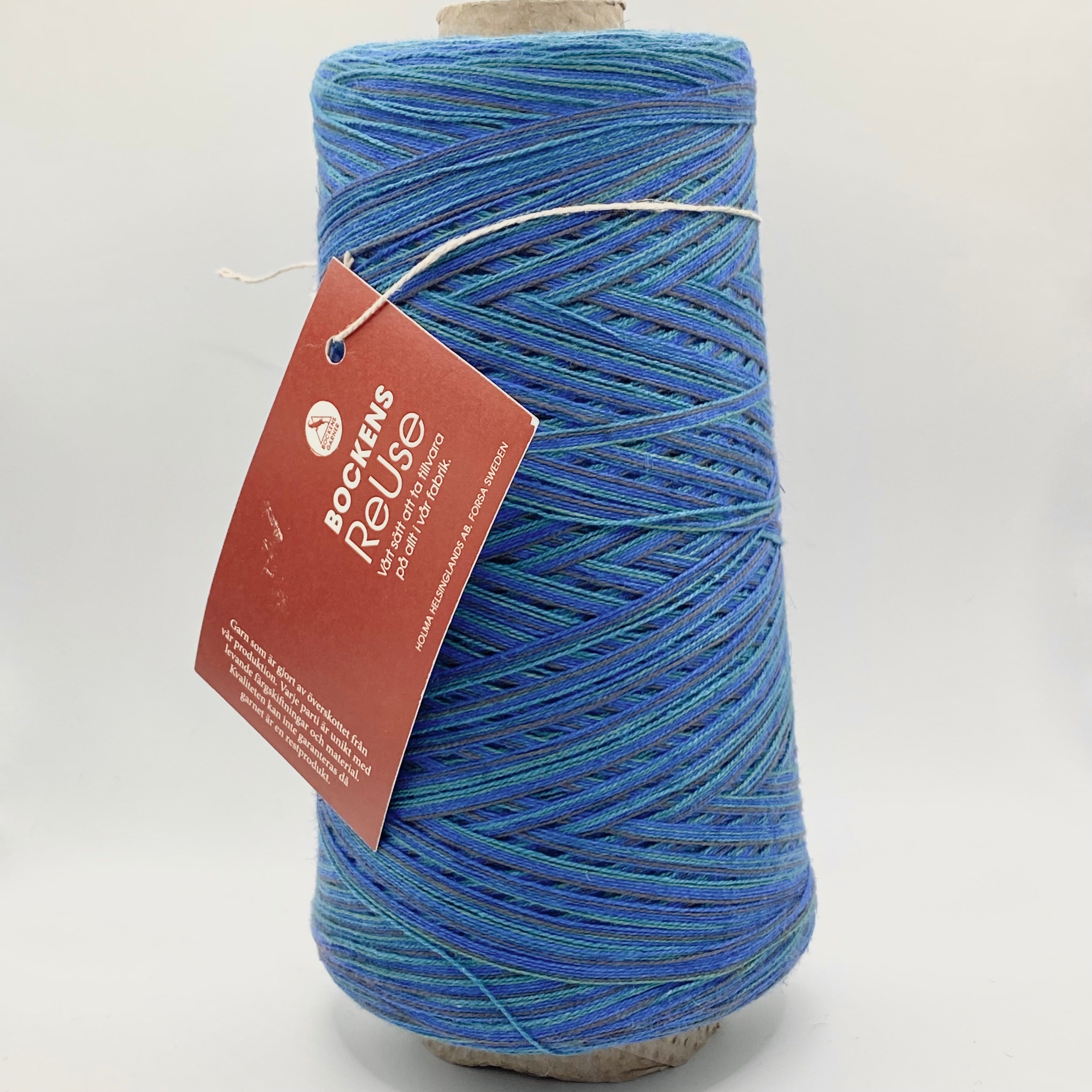 Cone of Bockens Garner ReUse yarn. Blues.